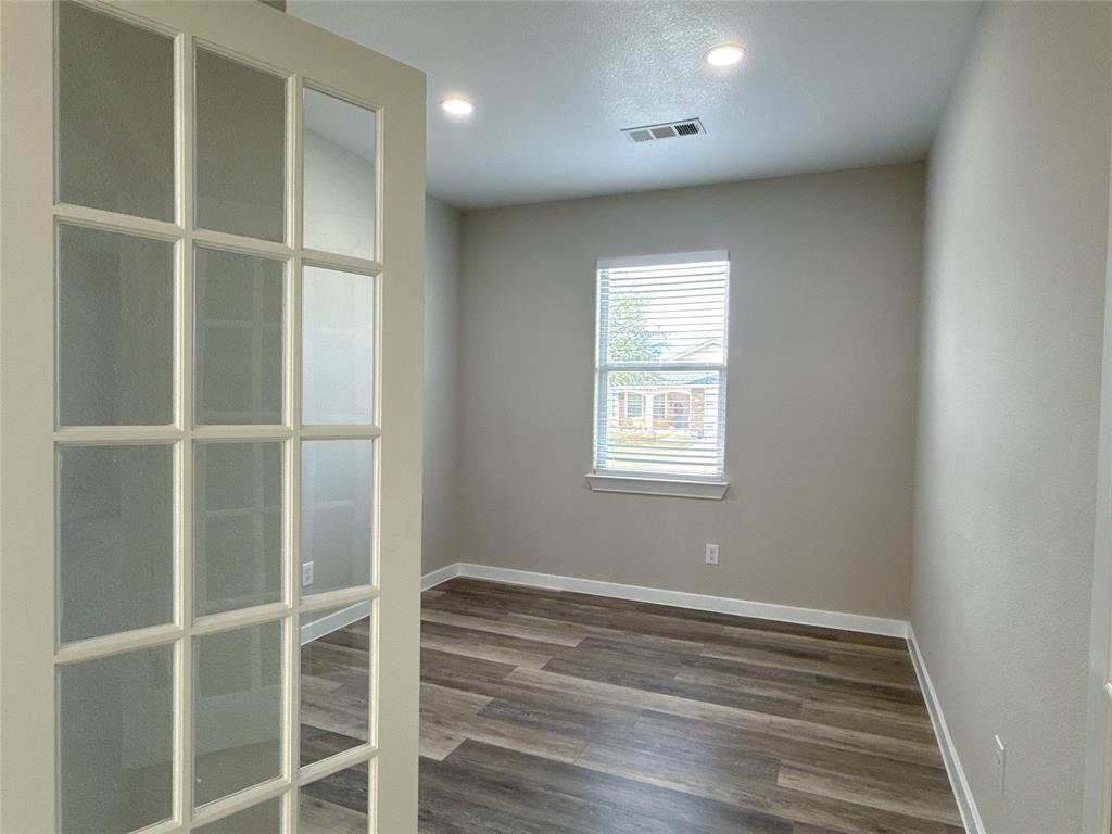 1913 Pin Oak Trail Anna, TX 75409 - Photo 12 of 17 a view of an empty room with wooden floor and a window