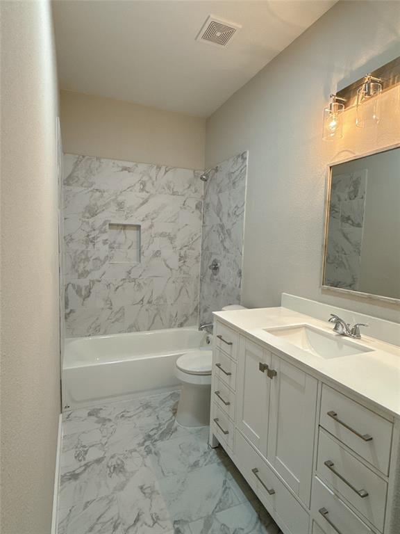 1913 Pin Oak Trail Anna, TX 75409 - Photo 13 of 17 a bathroom with a granite countertop toilet a sink and bathtub