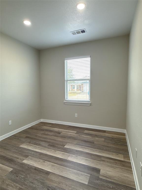 1913 Pin Oak Trail Anna, TX 75409 - Photo 14 of 17 an empty room with wooden floor and windows