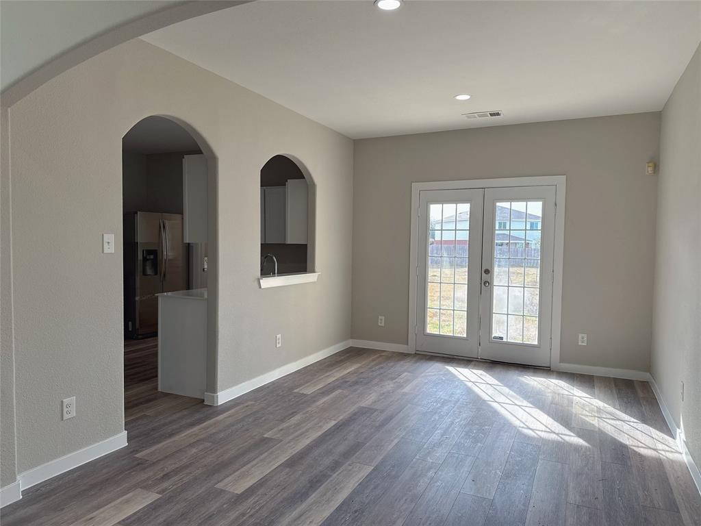 1913 Pin Oak Trail Anna, TX 75409 - Photo 6 of 17 a view of an empty room with wooden floor and a window
