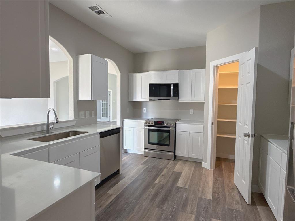 1913 Pin Oak Trail Anna, TX 75409 - Photo 8 of 17 a kitchen with a stove a sink and a microwave