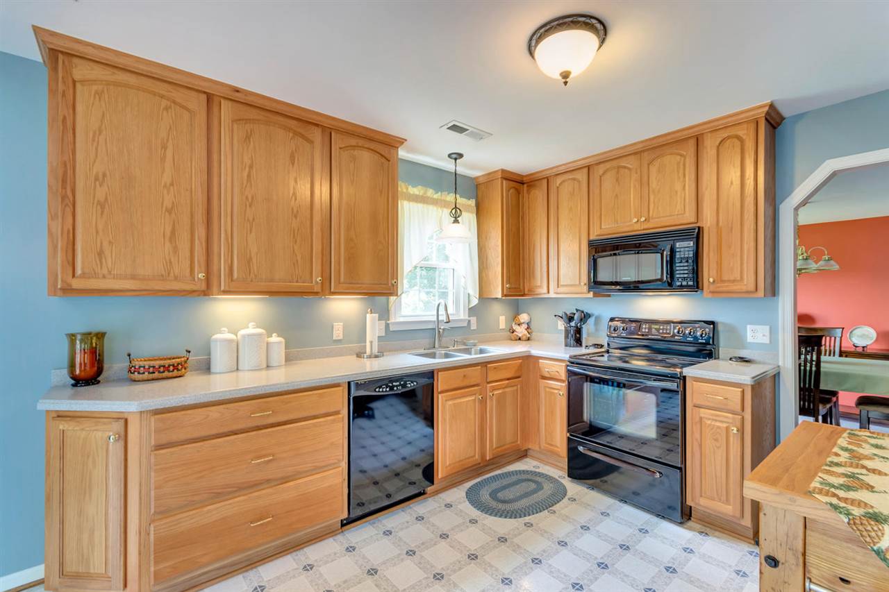 74 Spring Oaks Lane Ruckersville, VA 22968 - Photo 11 of 28 a kitchen with stainless steel appliances granite countertop a sink stove and microwave