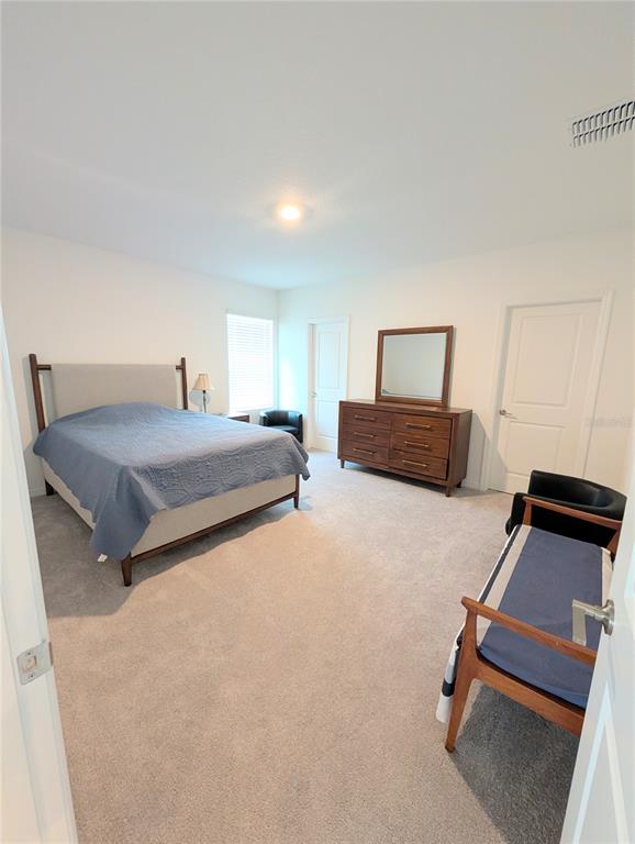 152 Jones Fish Camp Road Edgewater, FL 32141 - Photo 12 of 28 a bedroom with a bed and wooden floor