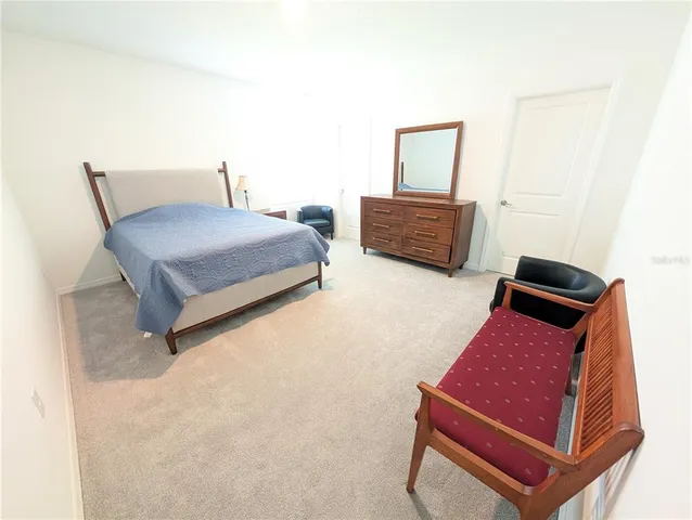 a bedroom with two beds and a couch
