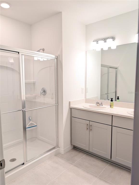 152 Jones Fish Camp Road Edgewater, FL 32141 - Photo 14 of 28 a bathroom with a double vanity sink mirror and shower