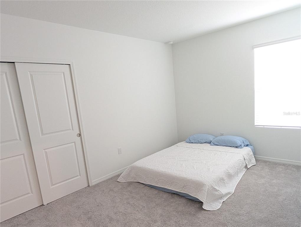 152 Jones Fish Camp Road Edgewater, FL 32141 - Photo 19 of 28 a bedroom with a bed and a window