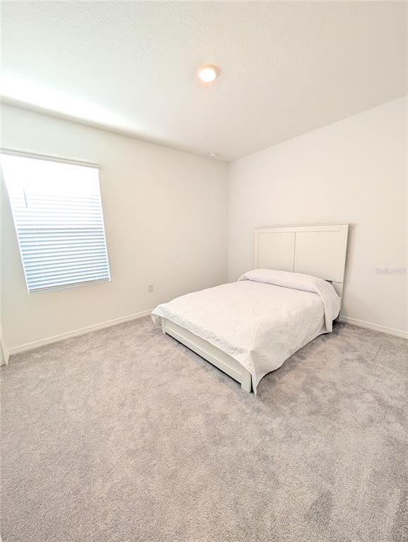 152 Jones Fish Camp Road Edgewater, FL 32141 - Photo 21 of 28 a bedroom with a bed and a cabinets