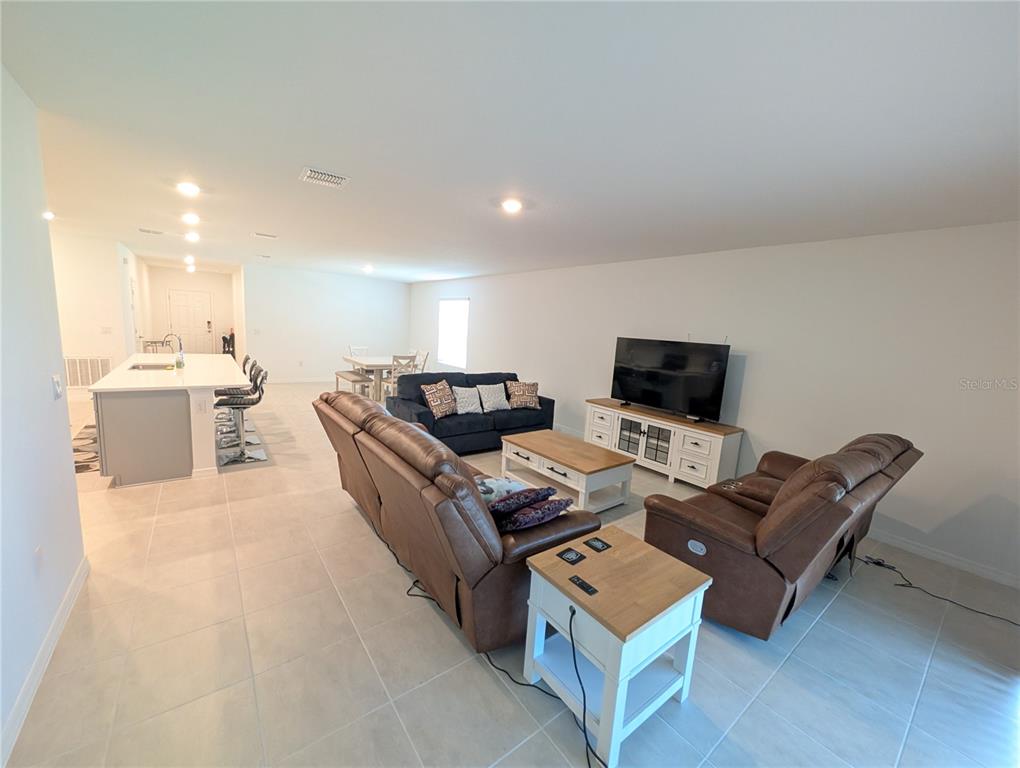 152 Jones Fish Camp Road Edgewater, FL 32141 - Photo 4 of 28 a living room with furniture and a flat screen tv