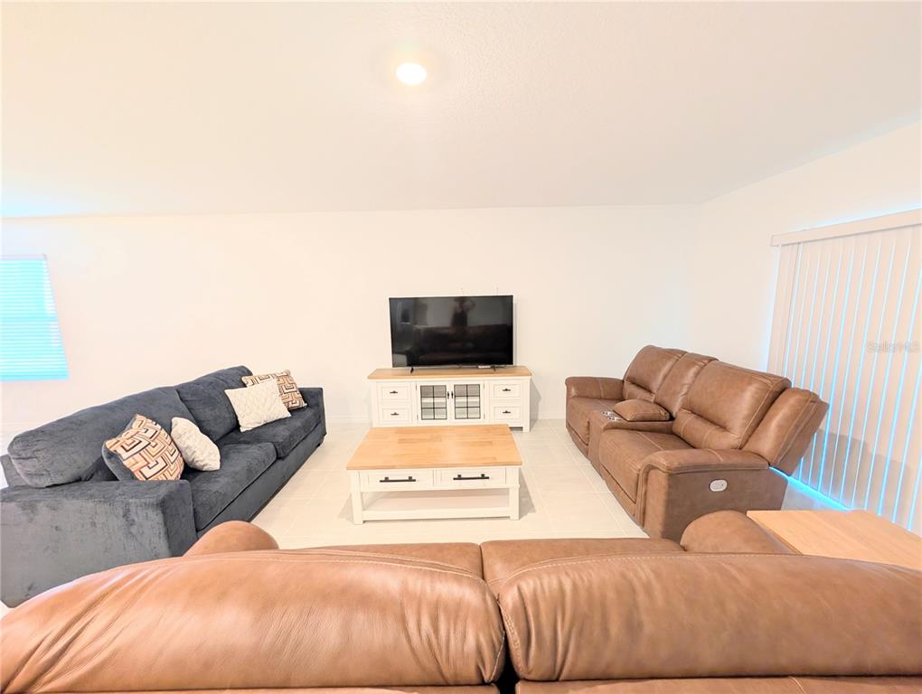 152 Jones Fish Camp Road Edgewater, FL 32141 - Photo 6 of 28 a living room with furniture and a flat screen tv