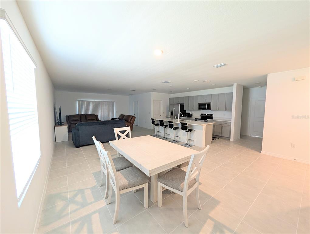 152 Jones Fish Camp Road Edgewater, FL 32141 - Photo 8 of 28 a kitchen with a dining table chairs and refrigerator