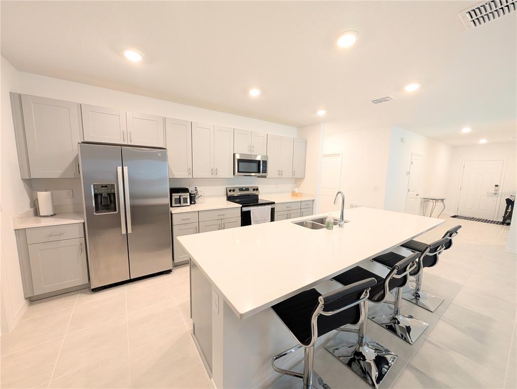 152 Jones Fish Camp Road Edgewater, FL 32141 - Photo 10 of 28 a kitchen with stainless steel appliances a refrigerator sink and microwave