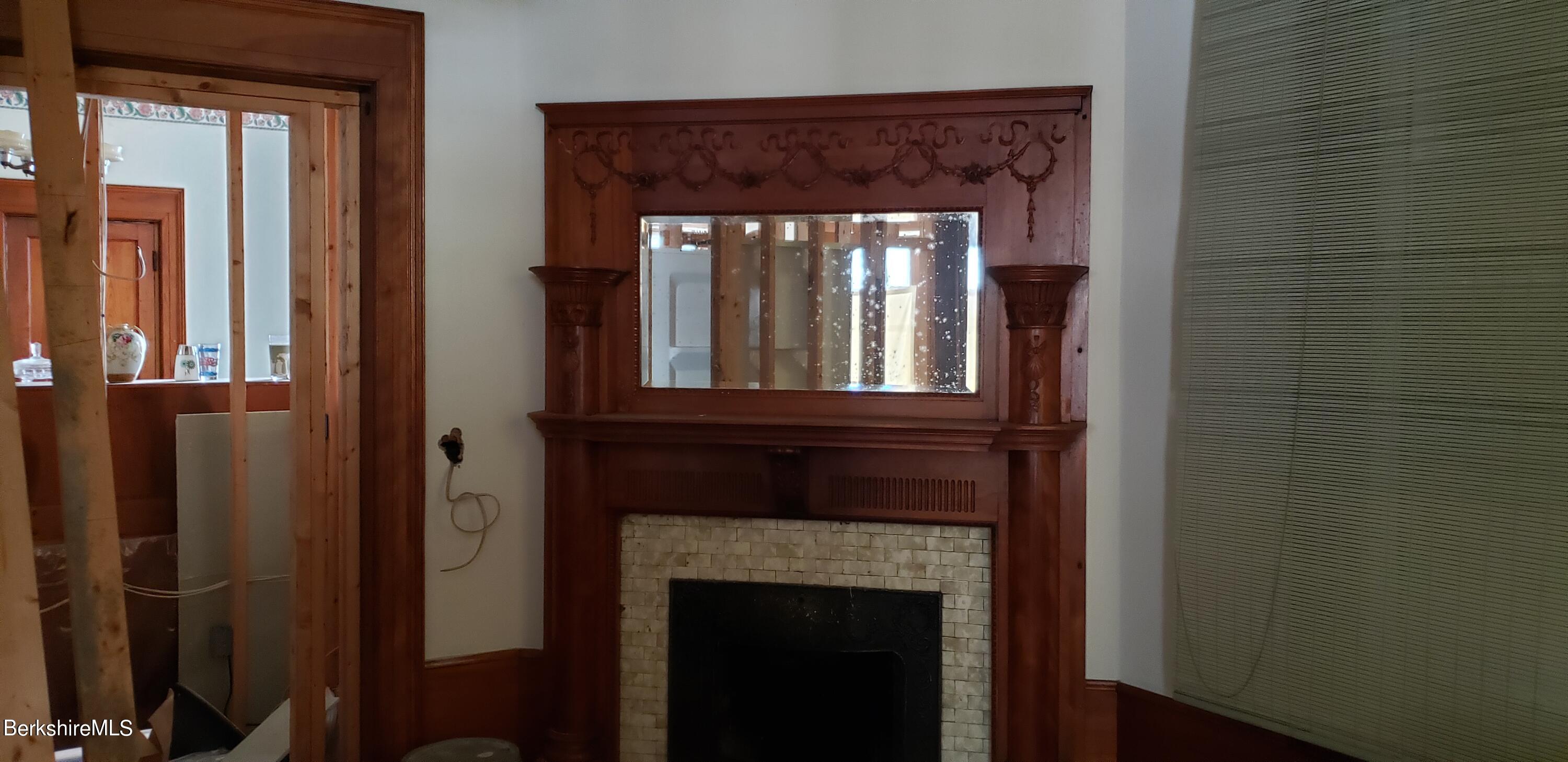 219-221 Church Street North Adams, MA 01247 - Photo 11 of 43 a view of a livingroom with a fireplace