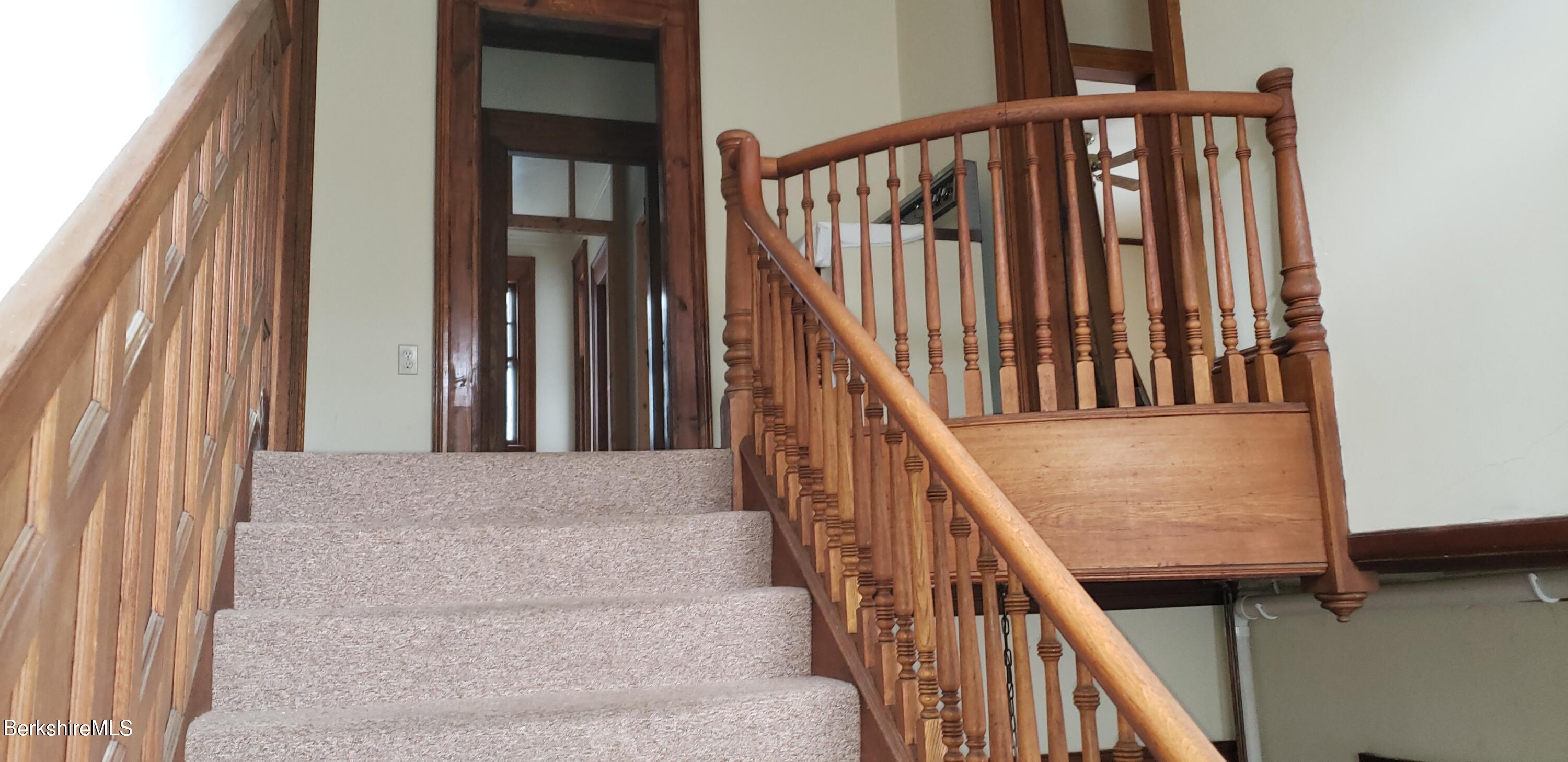 219-221 Church Street North Adams, MA 01247 - Photo 13 of 43 a view of staircase with railing and white walls