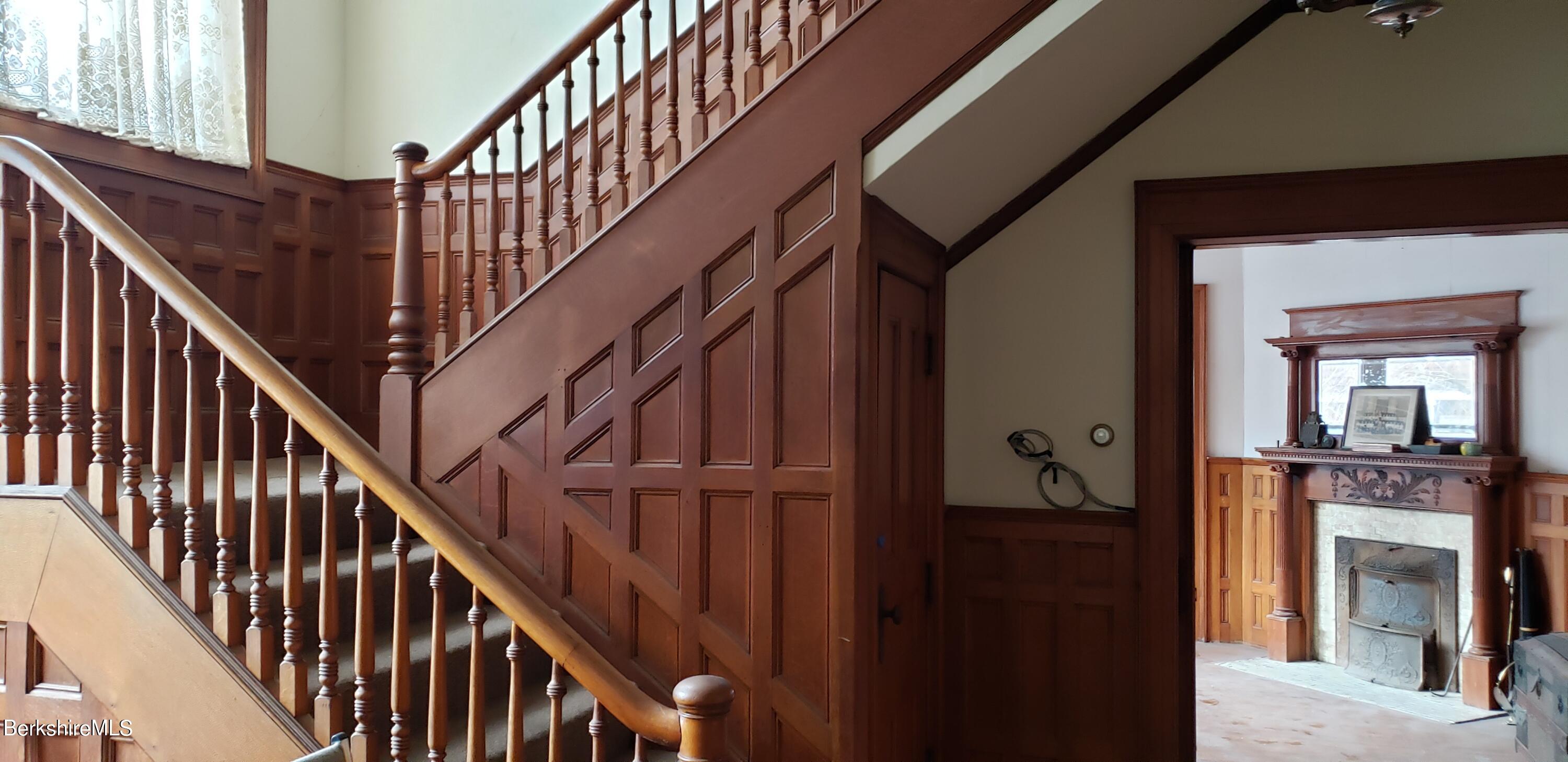 219-221 Church Street North Adams, MA 01247 - Photo 15 of 43 a view of staircase with wooden floor and stairs