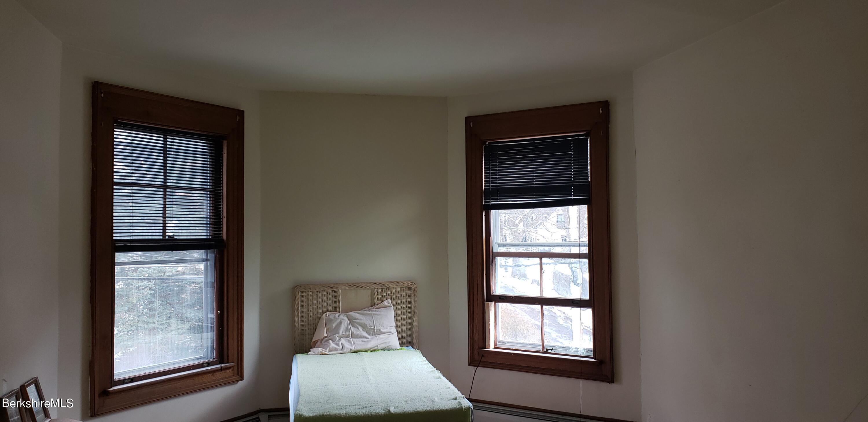 219-221 Church Street North Adams, MA 01247 - Photo 18 of 43 a bedroom with a bed and a window