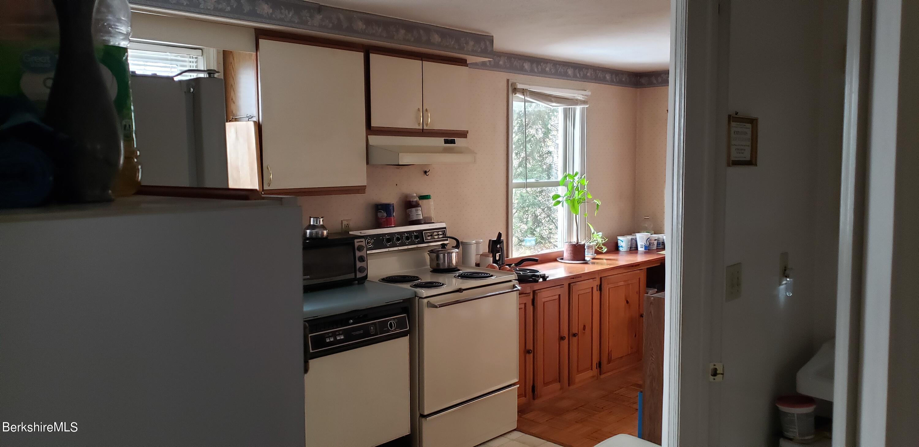 219-221 Church Street North Adams, MA 01247 - Photo 30 of 43 a kitchen with stainless steel appliances a sink and a refrigerator