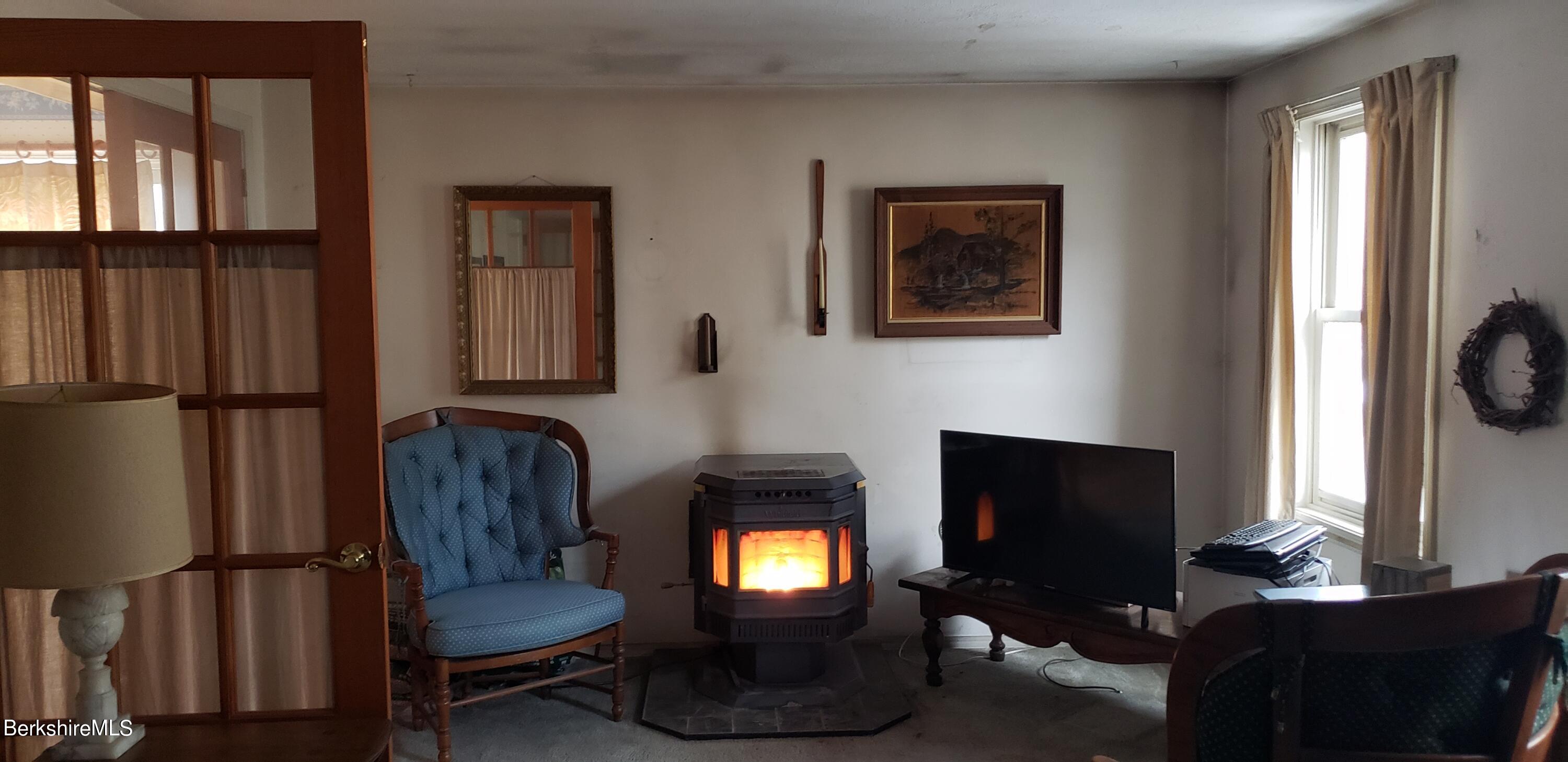 219-221 Church Street North Adams, MA 01247 - Photo 32 of 43 a living room with furniture and a fireplace