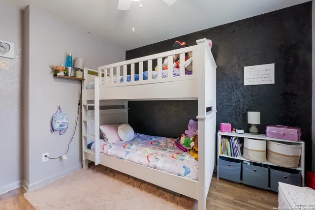 a bedroom with furniture and a book shelf