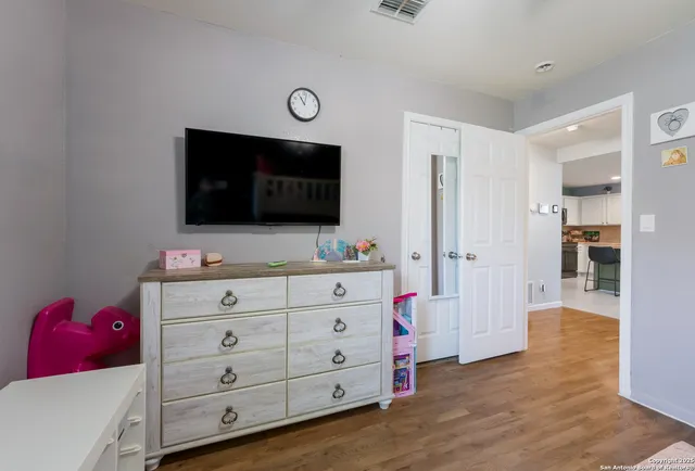 a view of room with cabinet flat screen tv and closet