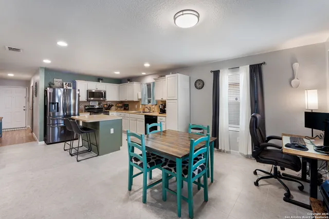 a view of kitchen with dining table and chairs