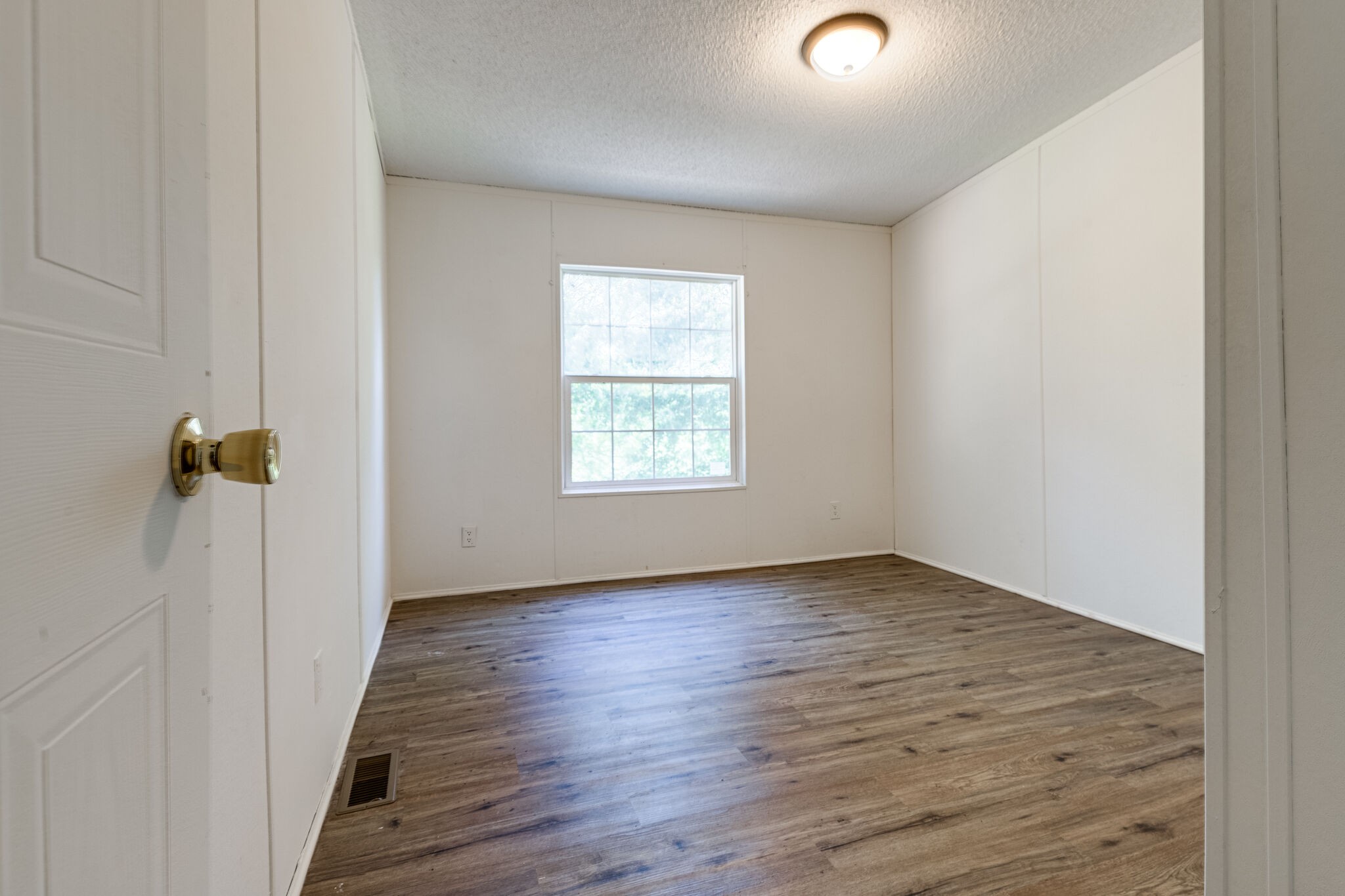 230 East Piney Road Dickson, TN 37055 - Photo 16 of 18 an empty room with wooden floor and windows