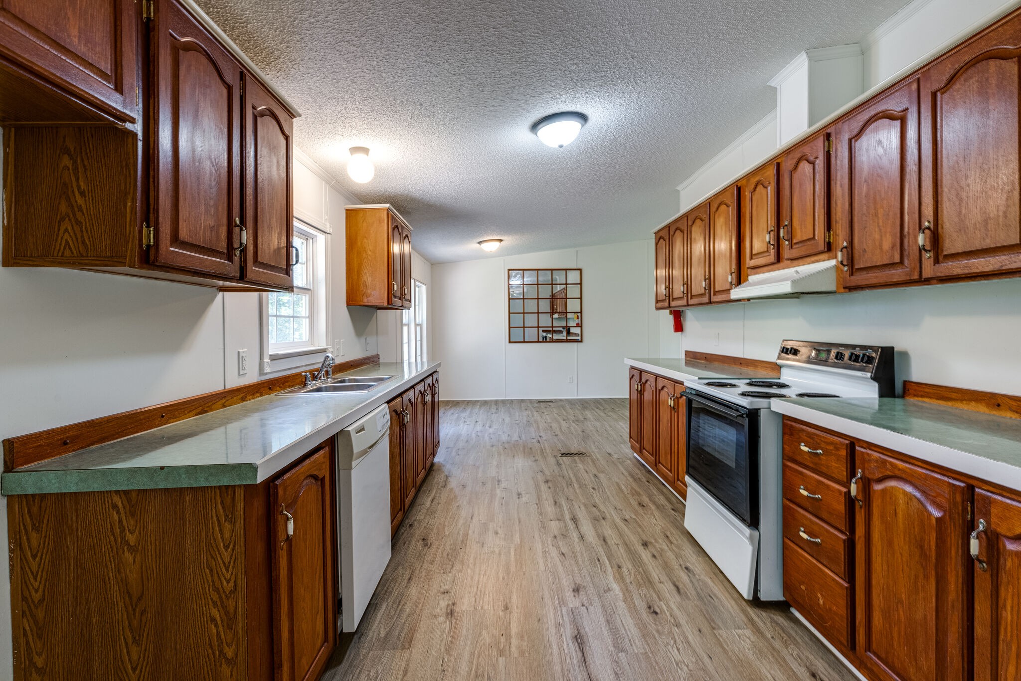230 East Piney Road Dickson, TN 37055 - Photo 3 of 18 a kitchen with stainless steel appliances granite countertop wooden cabinets a stove top oven a sink and dishwasher