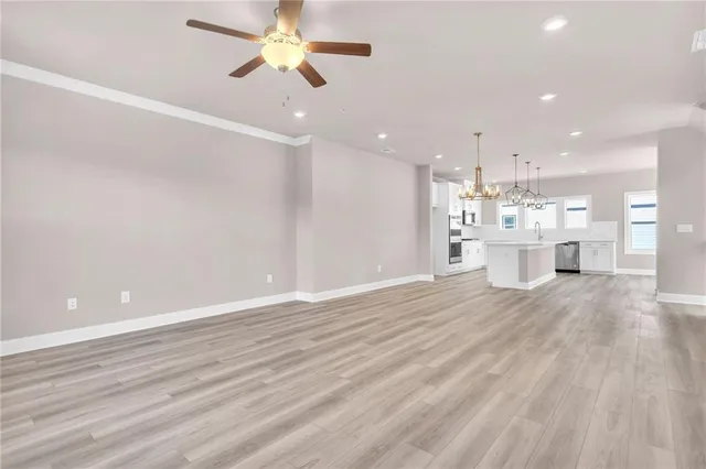 a view of a kitchen with a dishwasher and wooden floor
