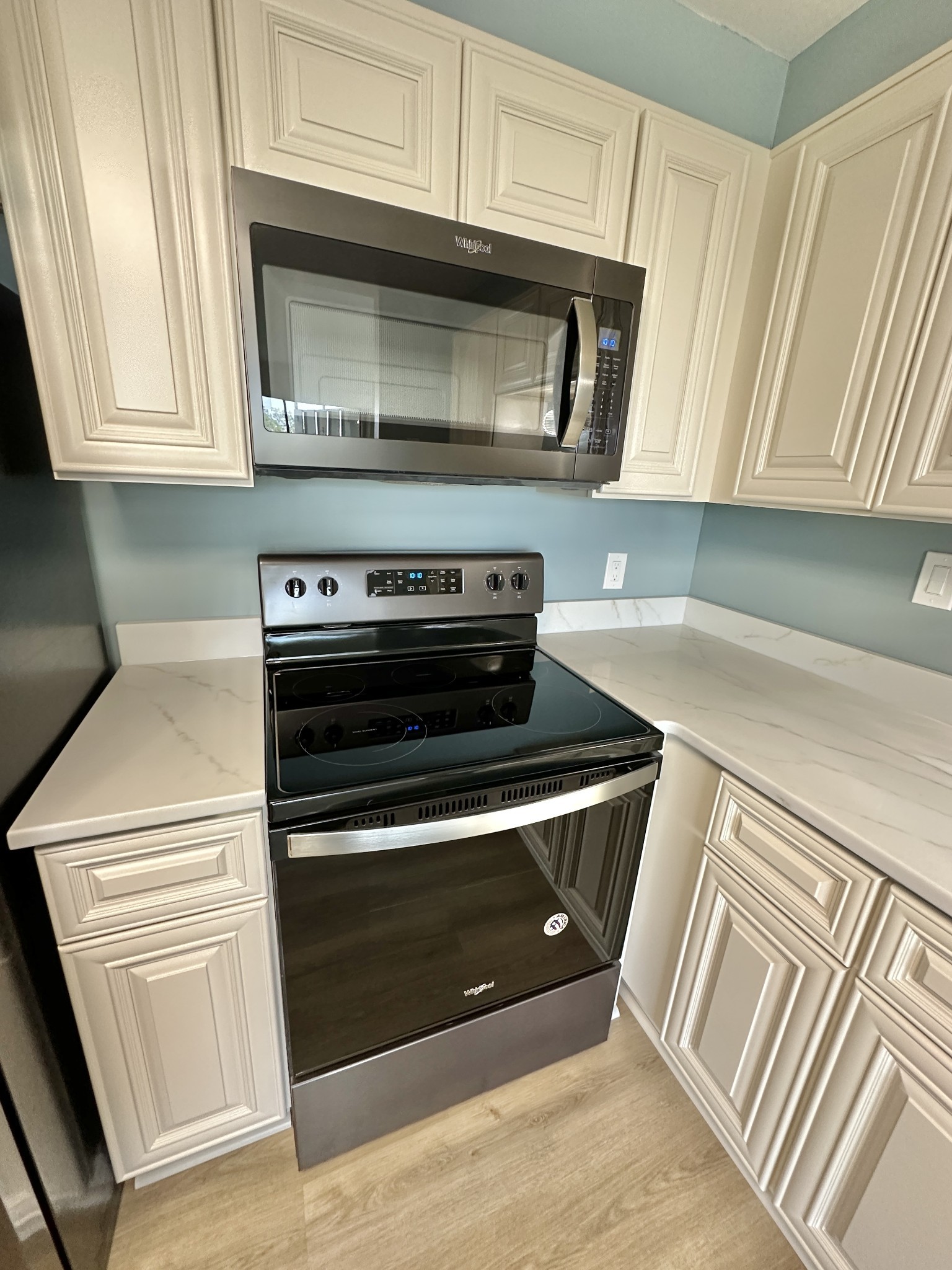4215 Harding Pike, Unit 903 Nashville, TN 37205 - Photo 20 of 68 a kitchen with granite countertop a stove microwave and sink