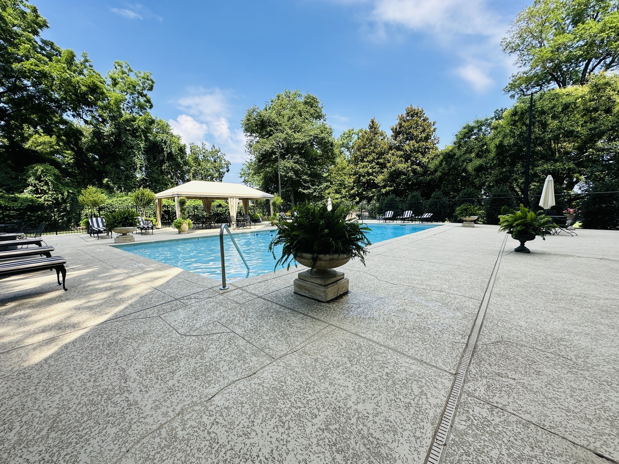 4215 Harding Pike, Unit 903 Nashville, TN 37205 - Photo 59 of 68 a view of a patio with a table and chairs under an umbrella