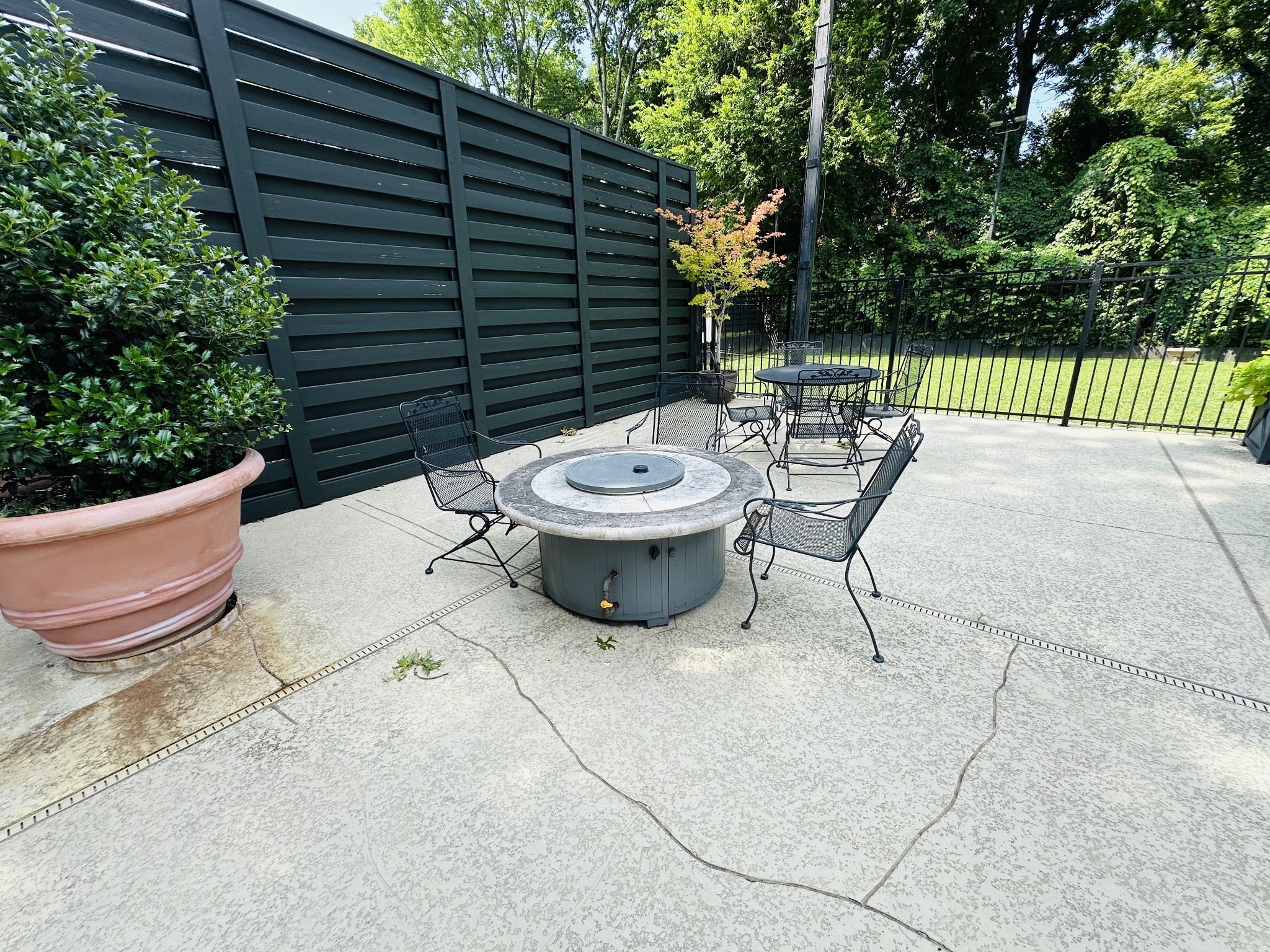 4215 Harding Pike, Unit 903 Nashville, TN 37205 - Photo 61 of 68 a view of a chairs and tables in the back yard of the house