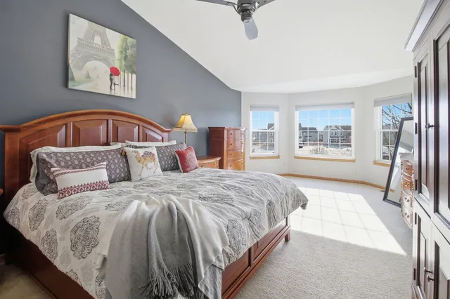 a bedroom with a large bed and a window