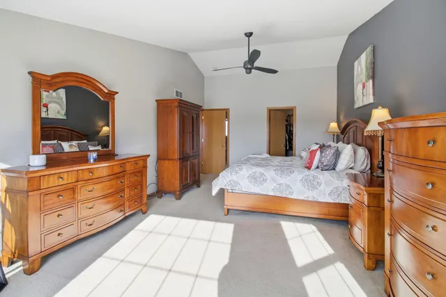 a bedroom with a large bed and a dresser