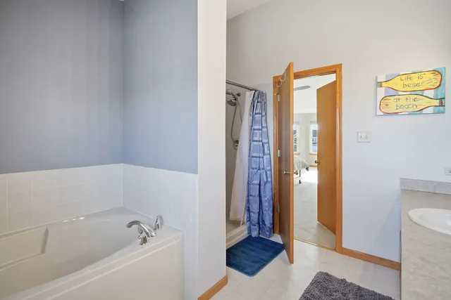 a bathroom with a bathtub and a shower