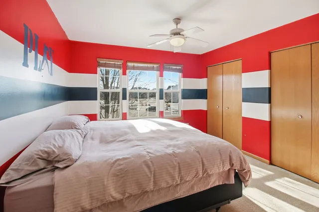 a bed sitting in a bedroom next to a window