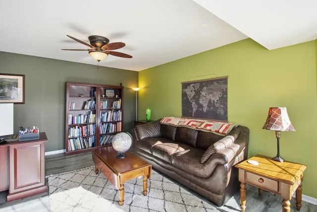 a living room with furniture a rug and a window
