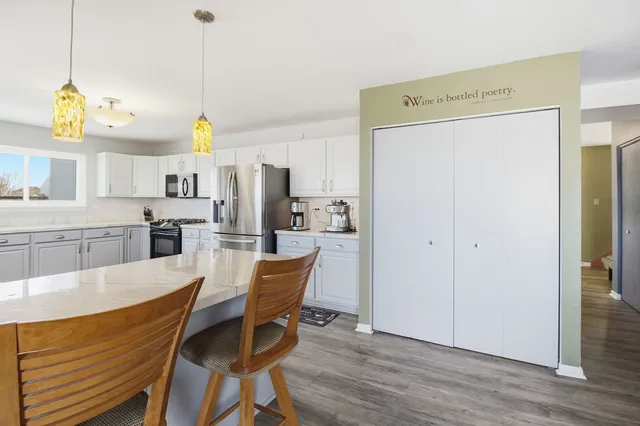 a view of kitchen with cabinets and stainless steel appliances