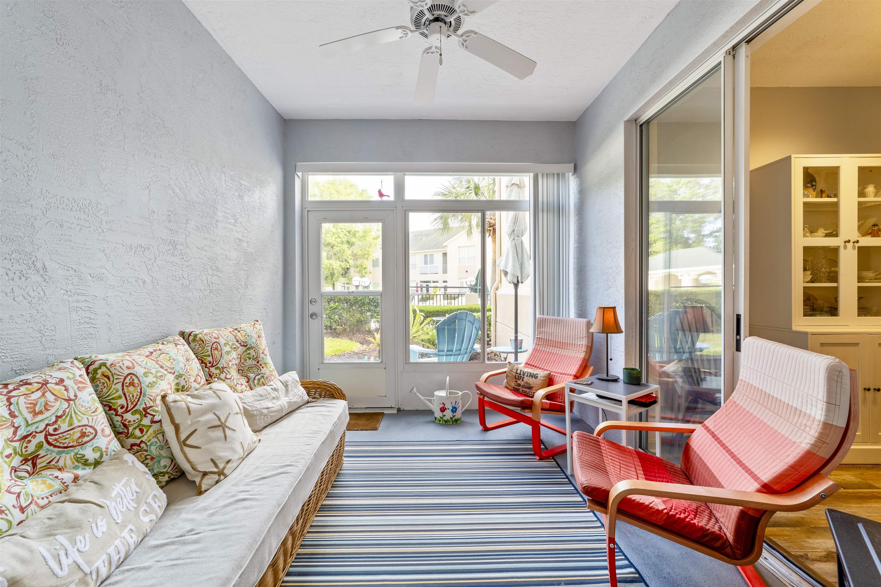 208 Augusta Circle St. Augustine, FL 32086 - Photo 18 of 34 a living room with furniture and floor to ceiling windows
