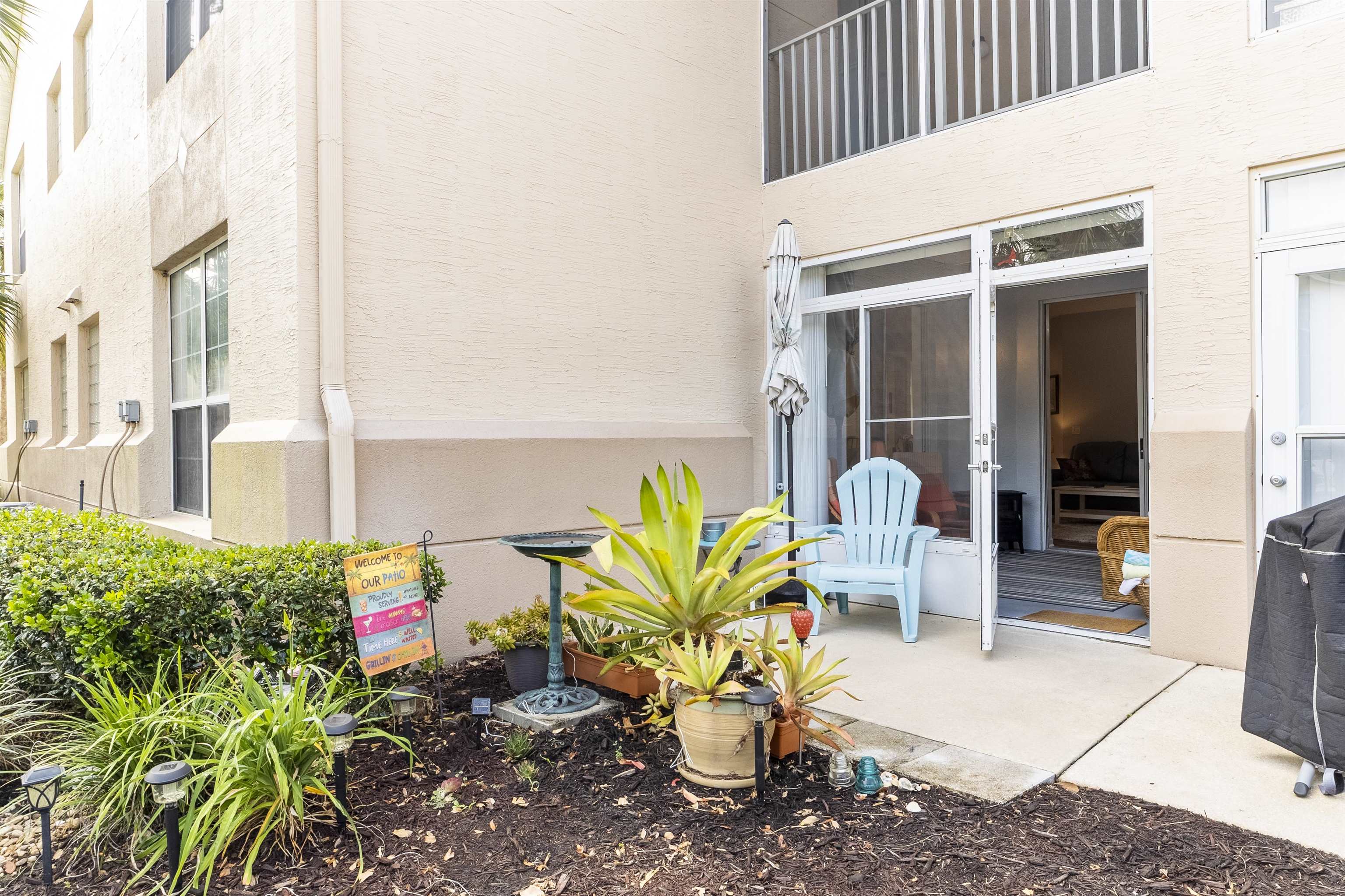 208 Augusta Circle St. Augustine, FL 32086 - Photo 20 of 34 a potted plant sitting in front of a building