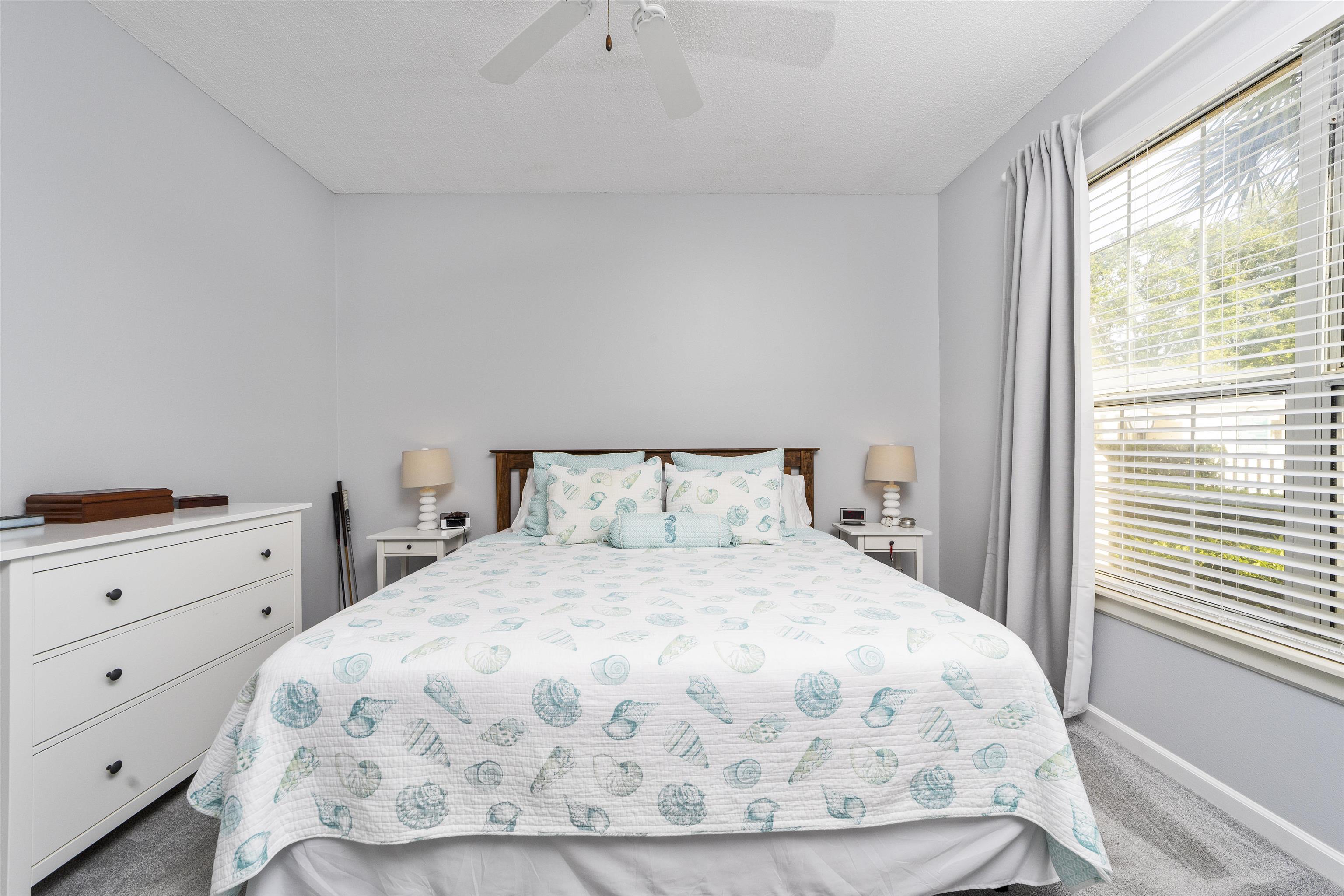 208 Augusta Circle St. Augustine, FL 32086 - Photo 22 of 34 a large bed sitting in a bedroom next to a window