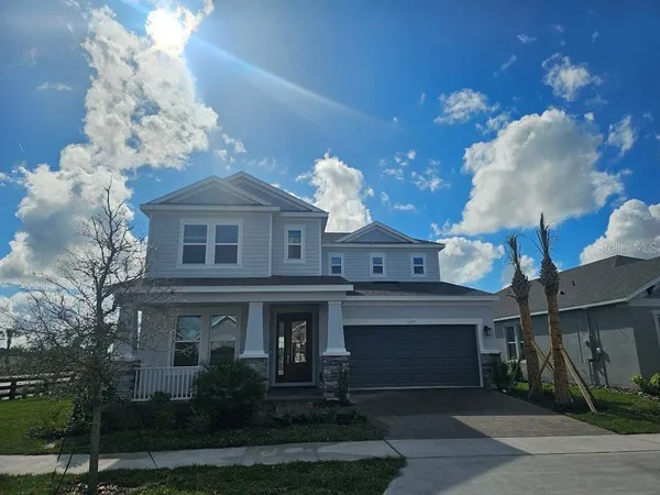 a front view of a house with plants