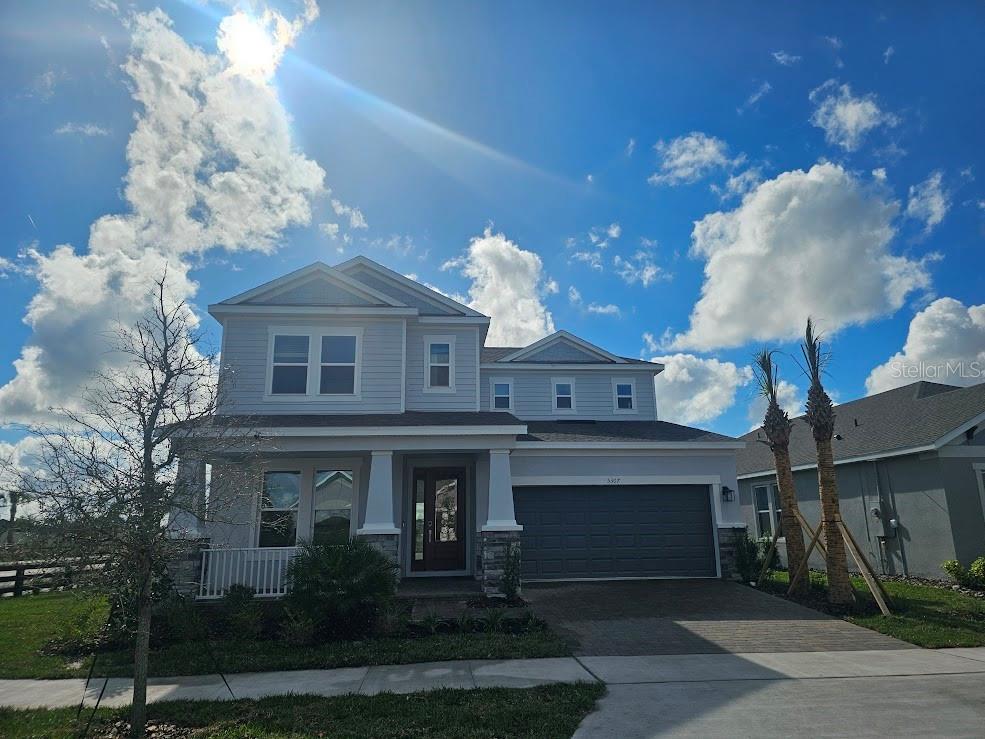a front view of a house with plants