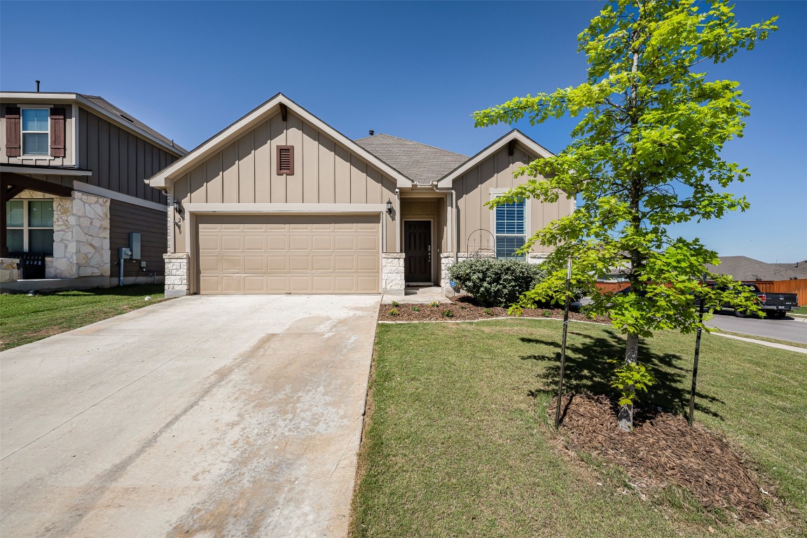 a front view of a house with a yard and a porch