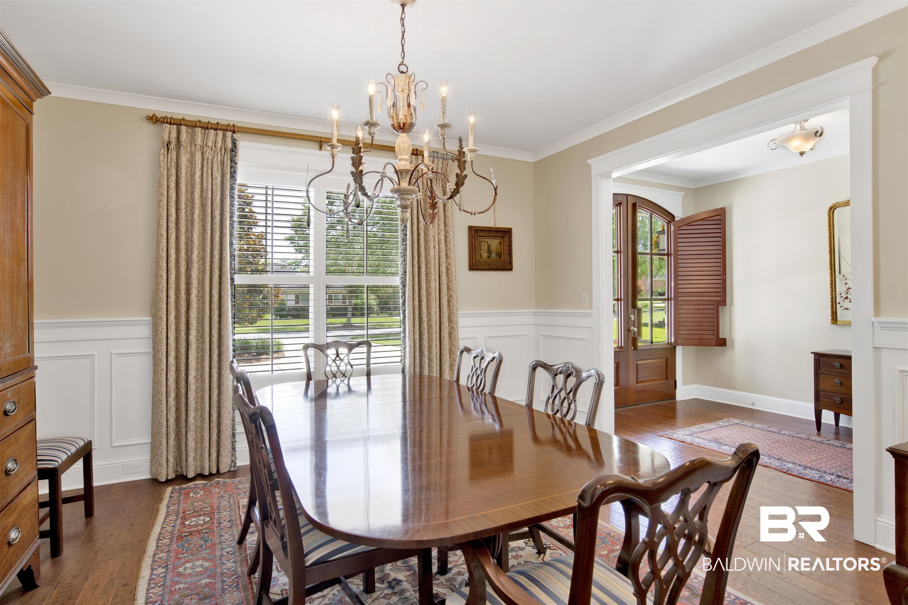 131 Sedgefield Avenue Fairhope, AL 36532 - Photo 10 of 50 Dining room featuring an inviting chandelier, crown molding, and hardwood / wood-style floors