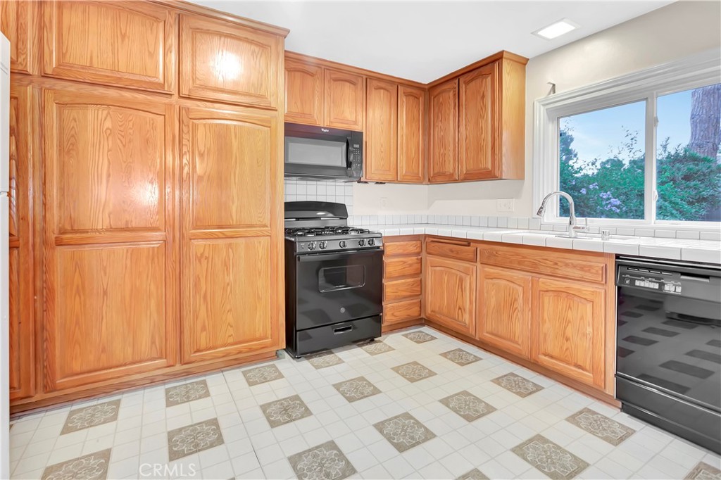106 Sequoia Tree Lane Irvine, CA 92612 - Photo 4 of 12 a kitchen with stainless steel appliances granite countertop a sink stove and cabinets