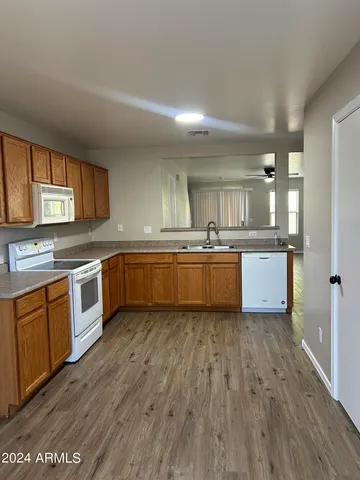 a large kitchen with a cabinets and wooden floor