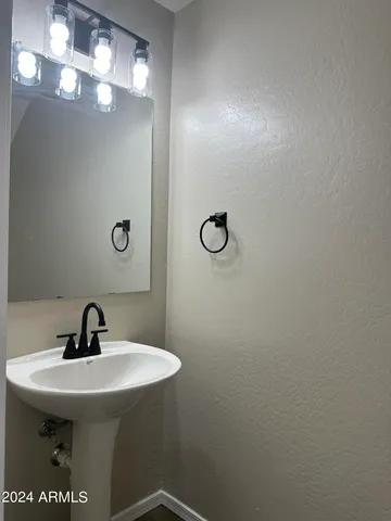 a bathroom with a sink and mirror