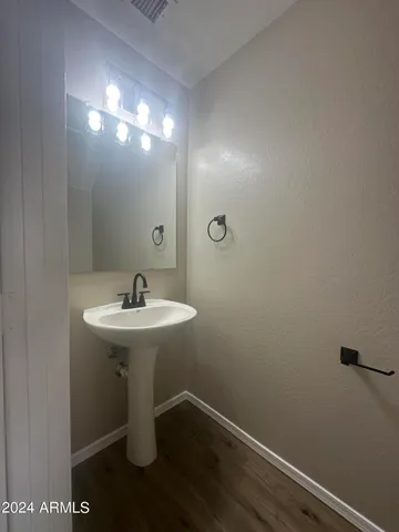 a bathroom with a sink a mirror and a toilet