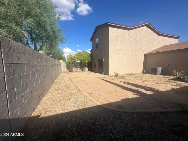a view of backyard with yellow lighting