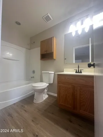 an empty room with ceiling fan and window