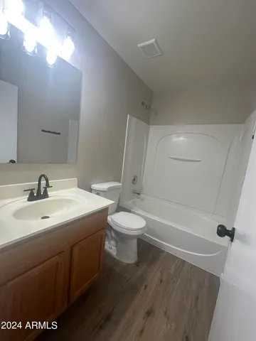 an empty room with fan and entrance